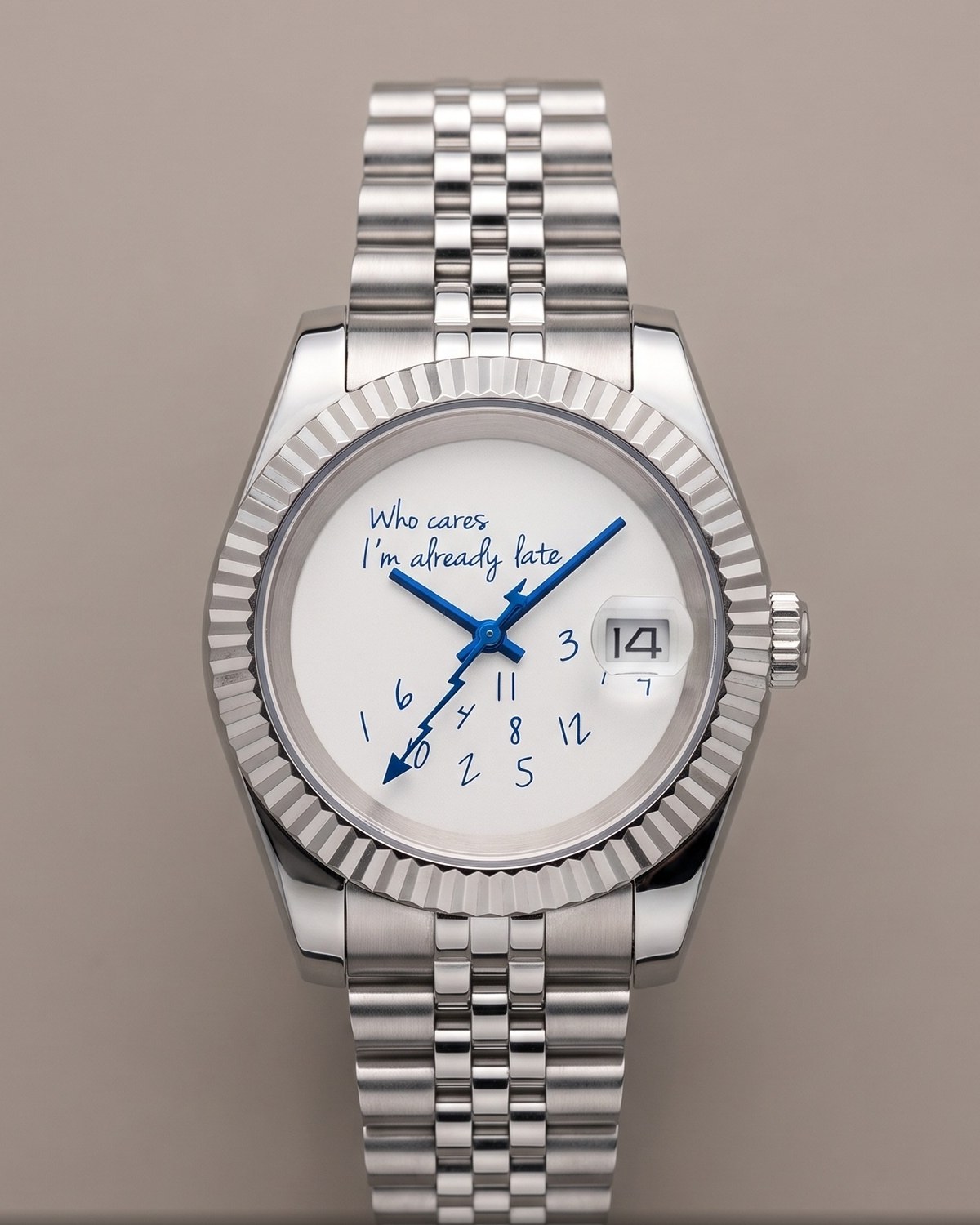 A finished Eximius watch, front on, with its handwriting-style dial and fluted bezel